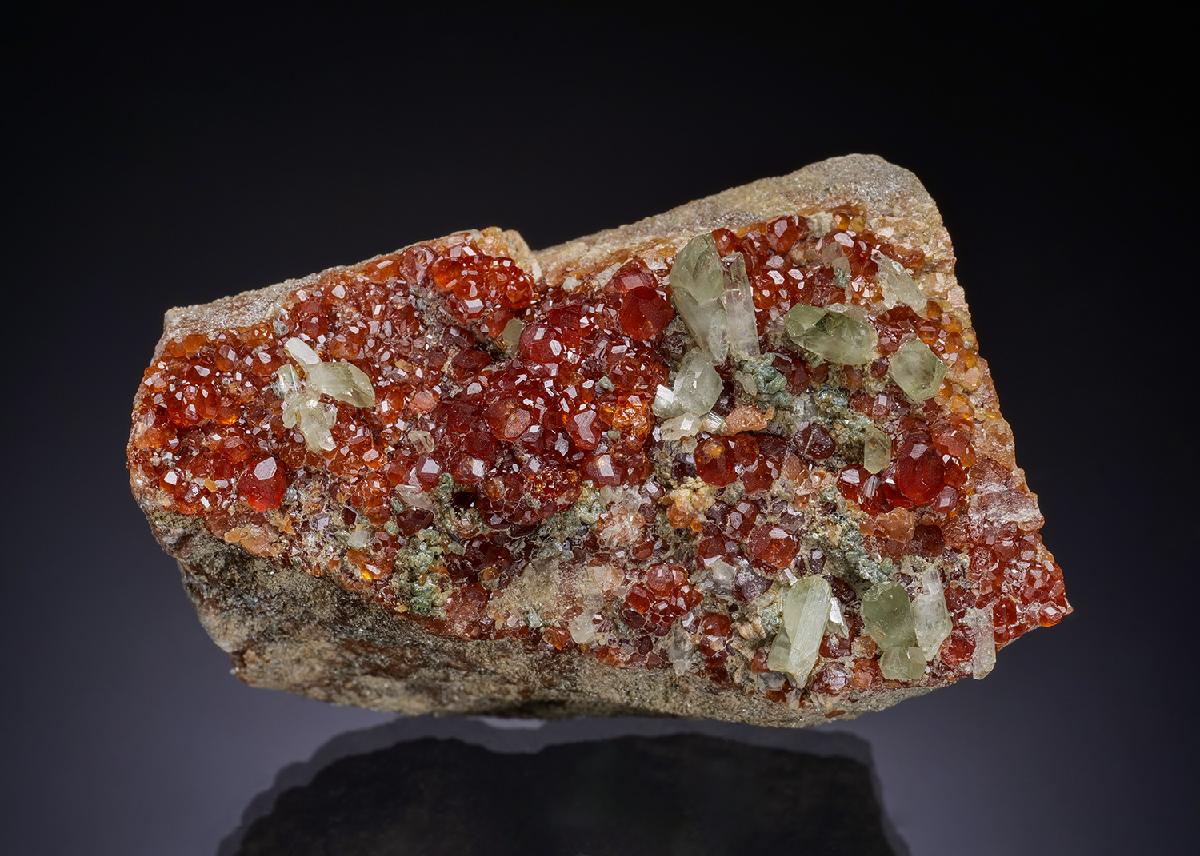 orange-red hessonite garnet with pale green diopside from Ala Valley — credit: Crystal Classics